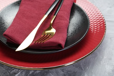 Photo of Clean plates, cutlery and napkin on table, closeup