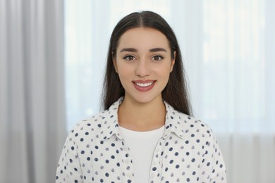 Portrait of beautiful young woman at home