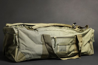 Photo of Army bag on dark grey background. Military equipment