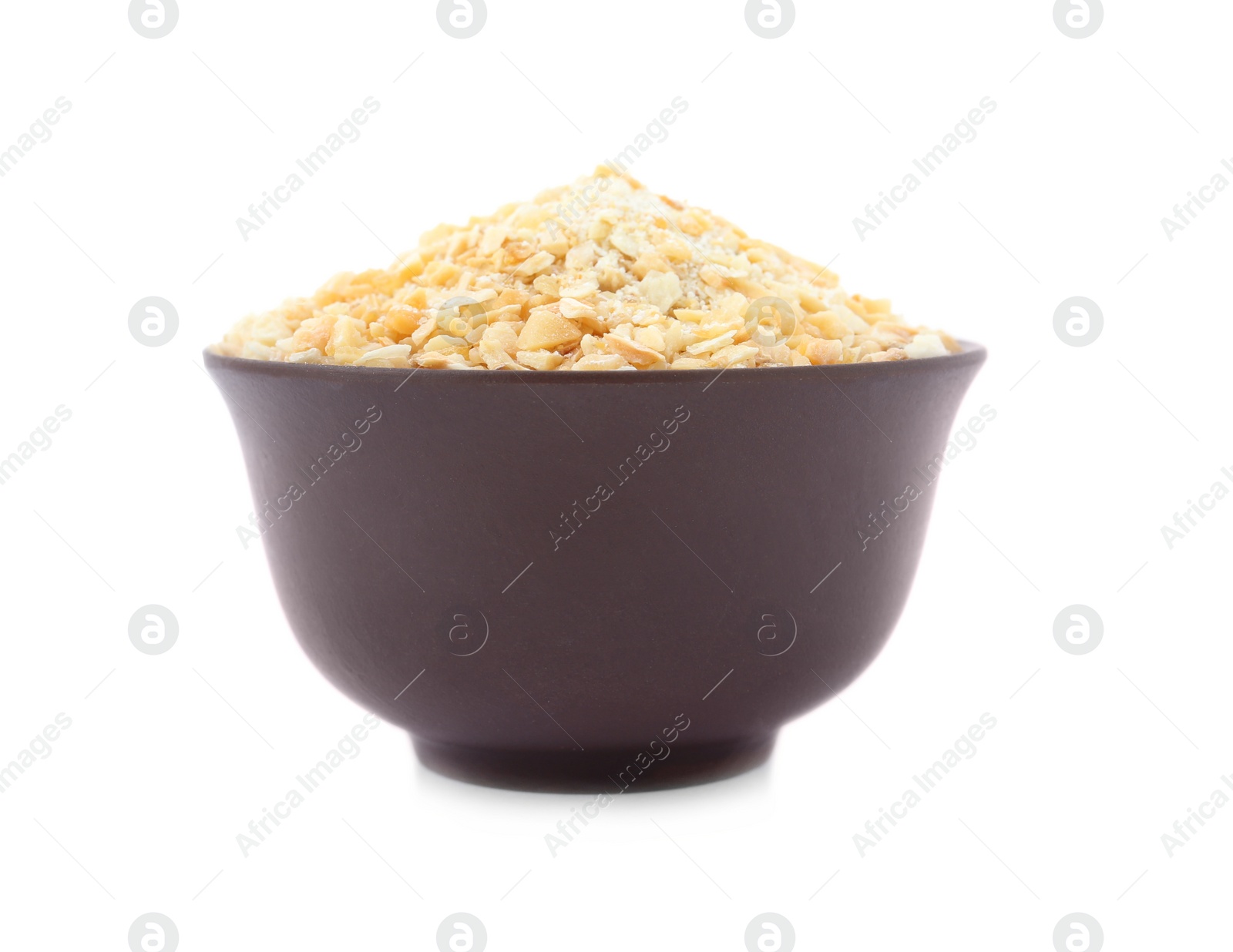 Photo of Bowl of granulated dry garlic on white background