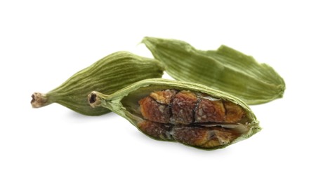 Dry green cardamom pods on white background, closeup