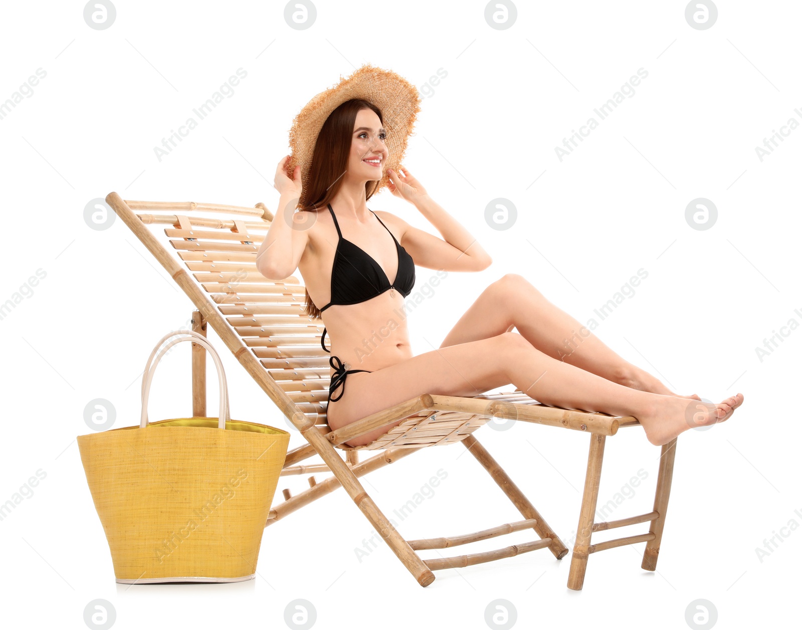 Photo of Young woman with bag on sun lounger against white background. Beach accessories