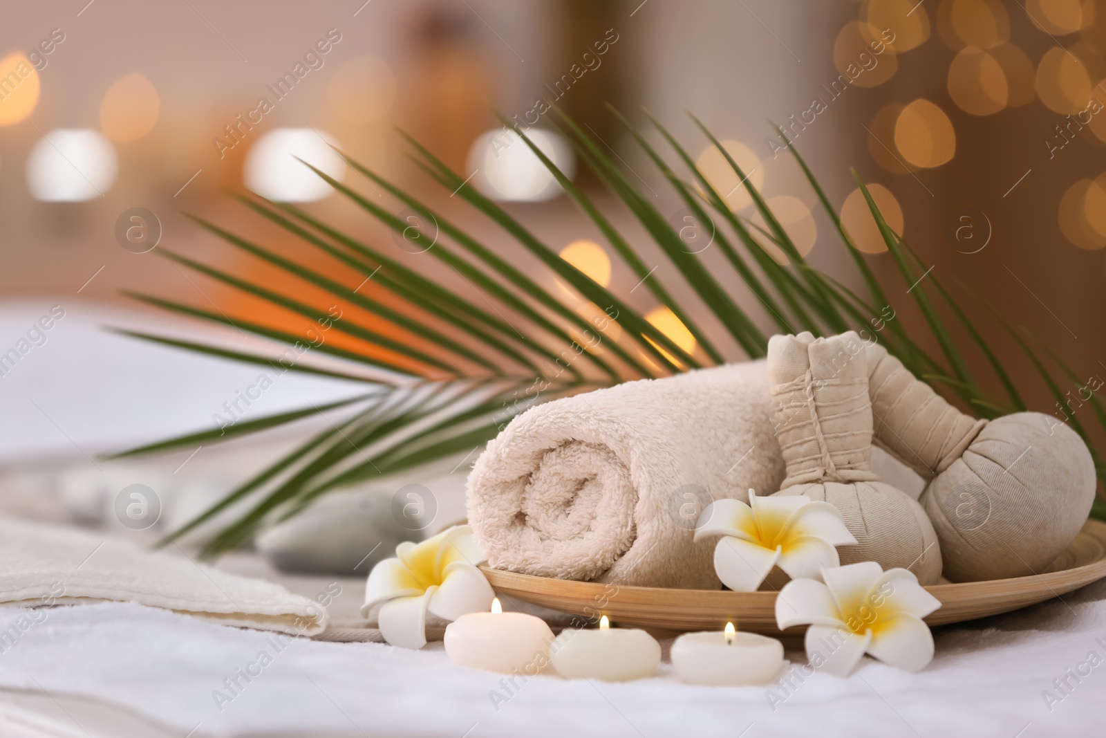 Photo of Beautiful spa composition on massage table in wellness center