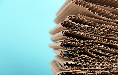 Photo of Stack of cardboard for recycling on color background, closeup. Space for text