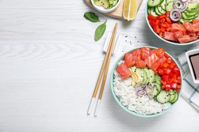 Photo of Delicious poke bowl with salmon and vegetables served on white wooden table, flat lay. Space for text