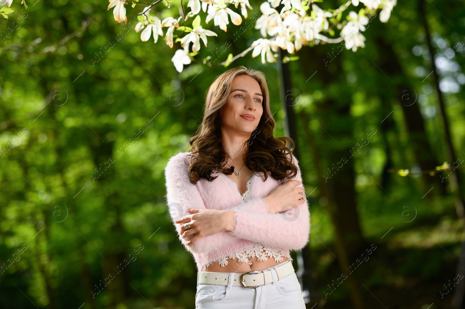 Photo of Beautiful young woman near blossoming tree on spring day