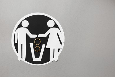 Photo of Divorce concept. Paper cutouts of couple, trash can and rings on light grey background, flat lay with space for text