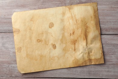 Sheet of old parchment paper on wooden table, top view