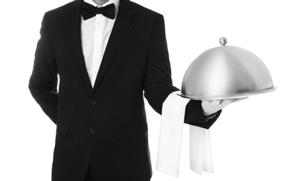 Photo of Waiter holding metal tray with lid on white background, closeup