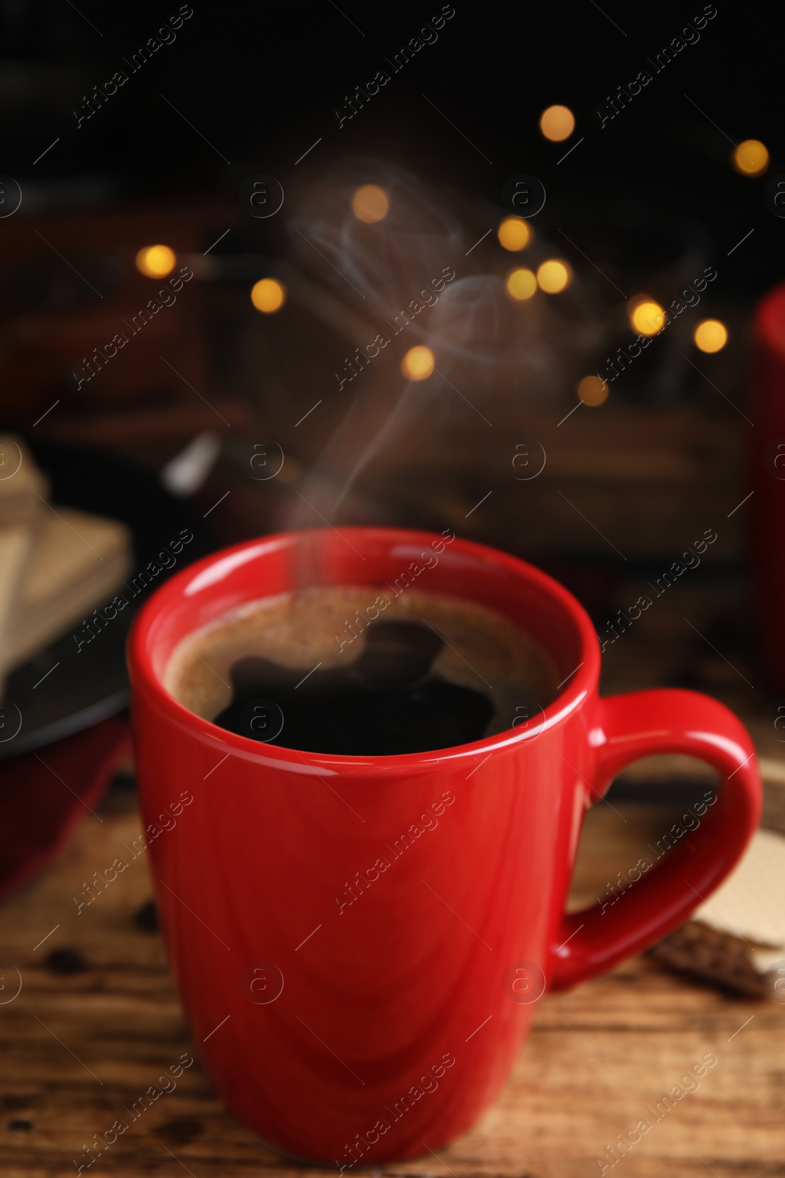 Photo of Delicious coffee and wafers on wooden table