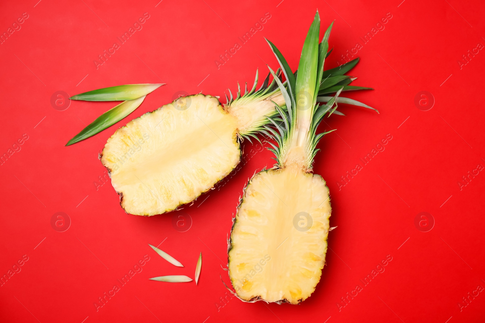 Photo of Fresh pineapple halves on color background