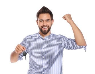 Happy young man with car key on white background. Getting driving license