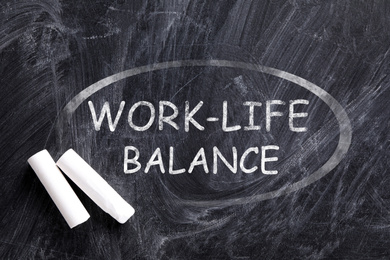 Image of Phrase Work-life balance written on blackboard, top view