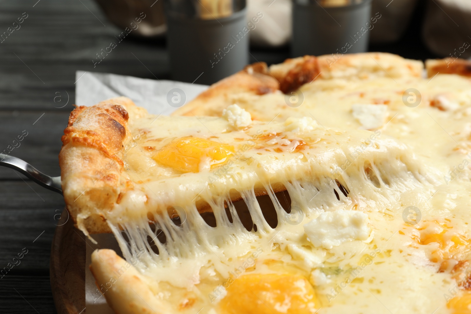 Photo of Taking slice of hot cheese pizza Margherita on table, closeup