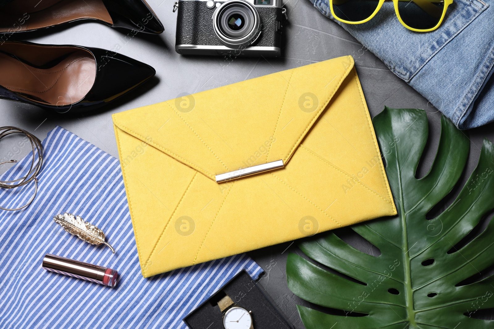 Photo of Flat lay composition with stylish bag and women's accessories on grey background