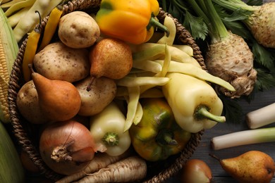Photo of Different fresh ripe vegetables and fruits on grey wooden table, closeup