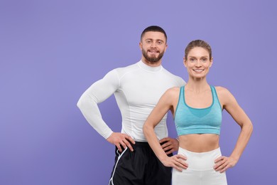 Portrait of happy athletic people on purple background, space for text
