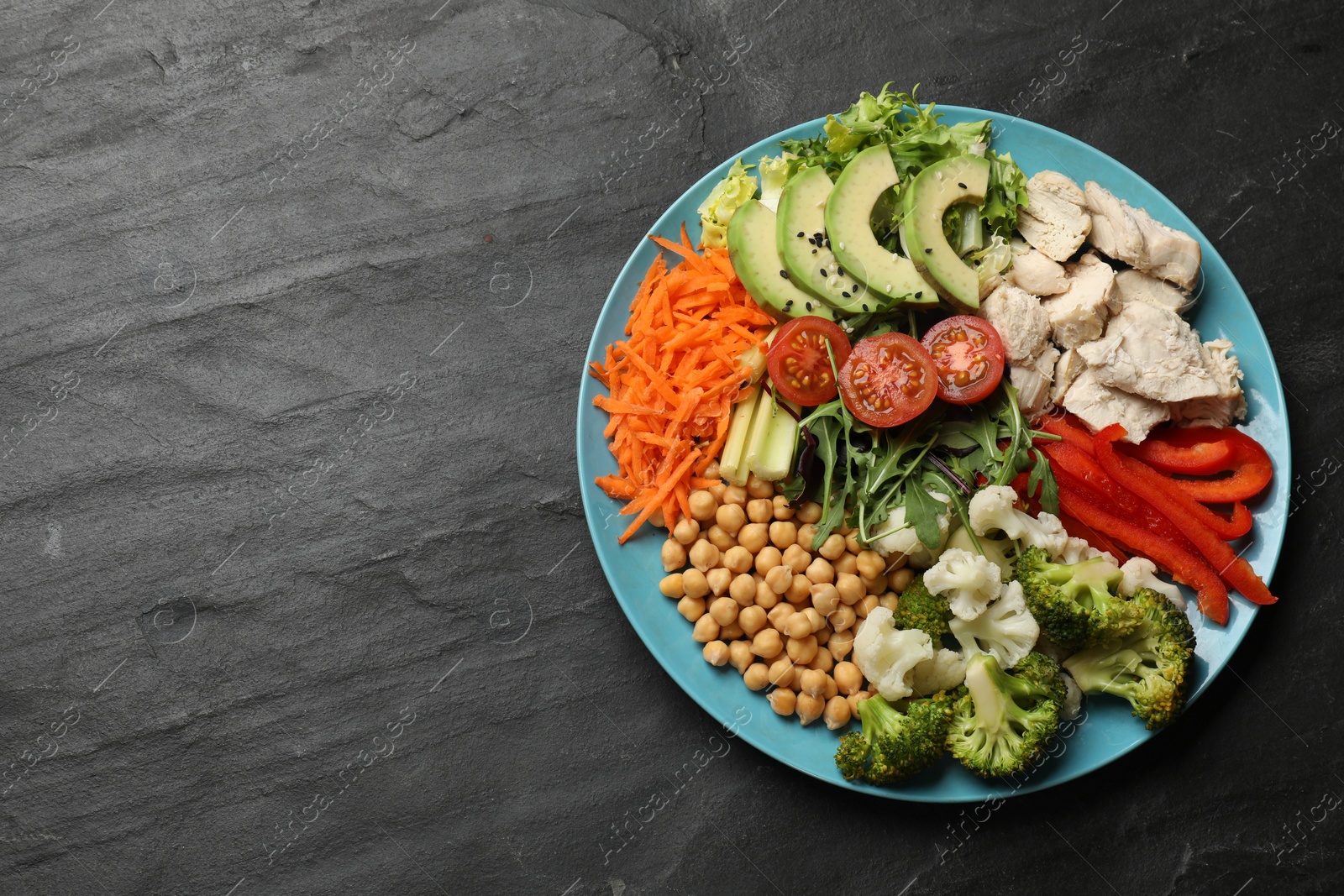 Photo of Balanced diet and healthy foods. Plate with different delicious products on black table, top view. Space for text