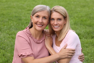 Photo of Happy mature mother and her daughter outdoors