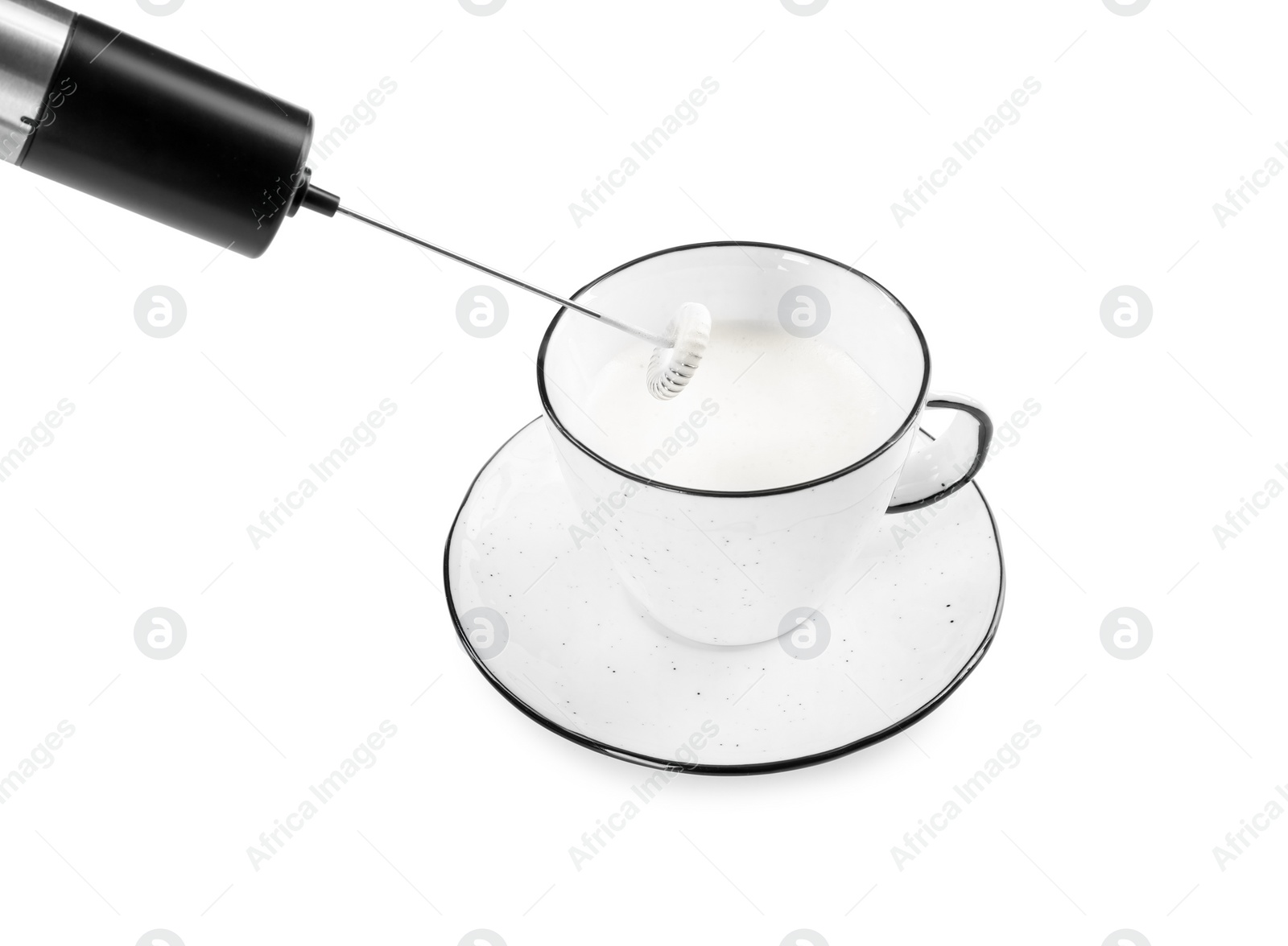 Photo of Whisking milk in cup with mini mixer (frother wand) isolated on white