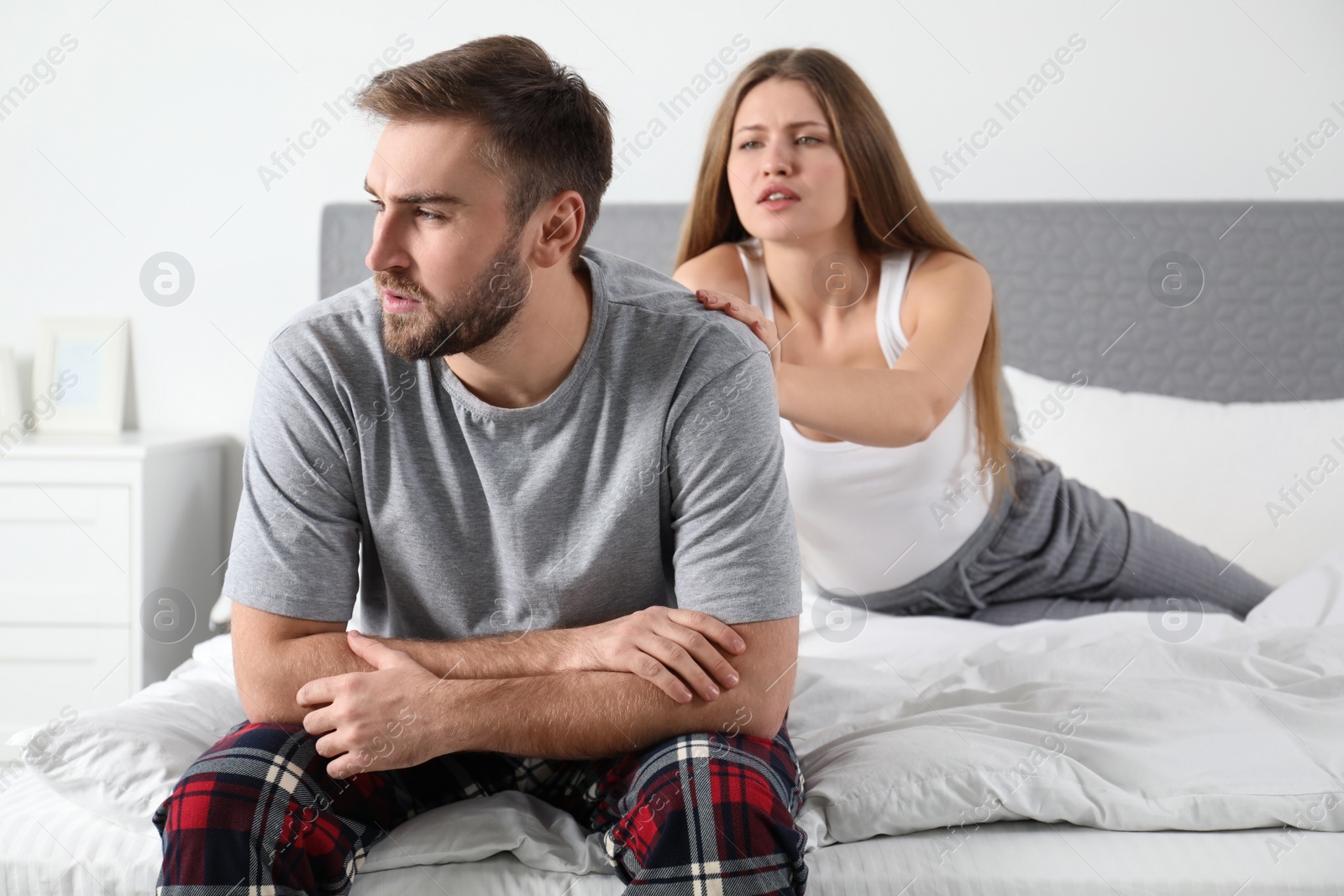 Photo of Young couple with relationship problems in bedroom