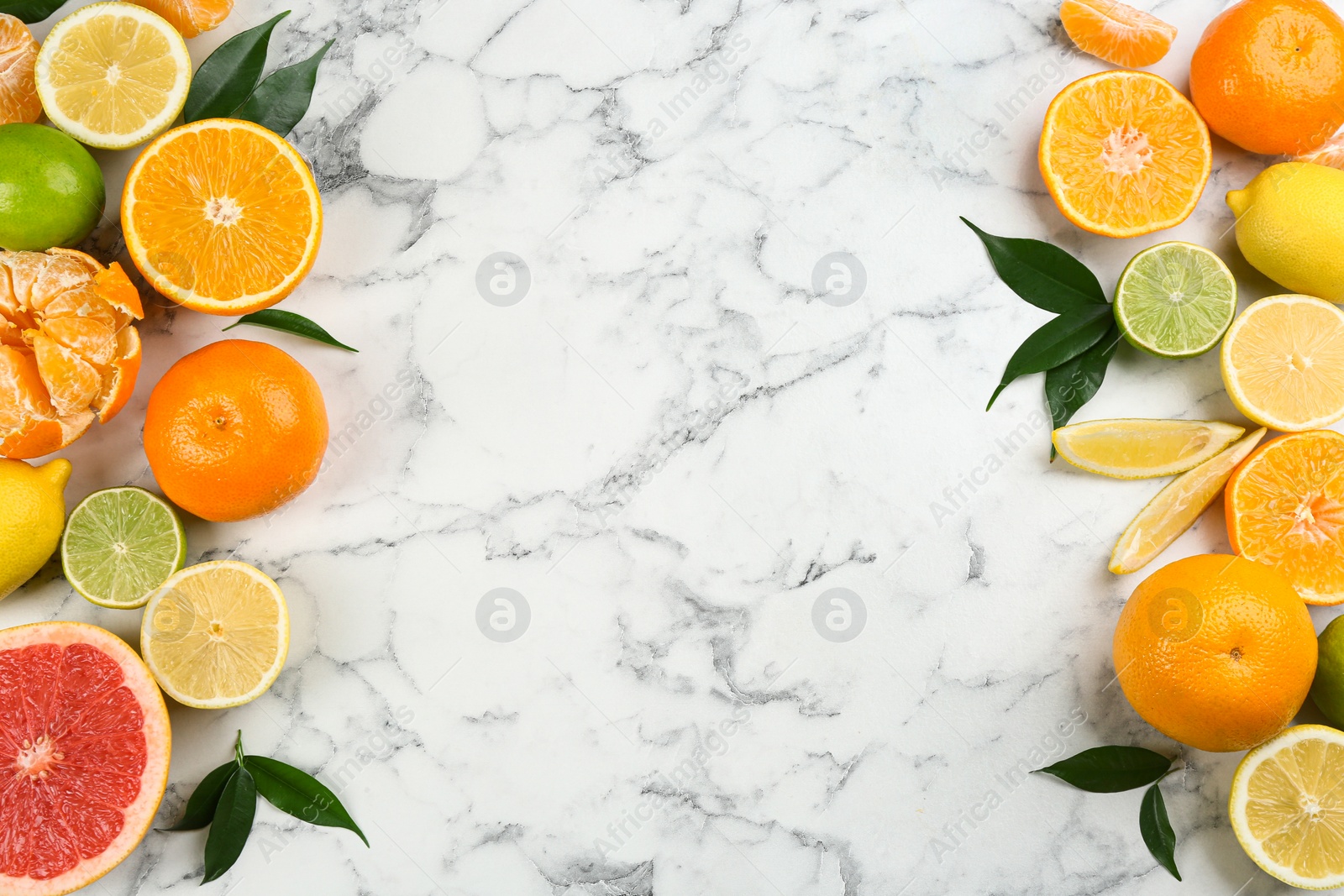 Photo of Flat lay composition with tangerines and different citrus fruits on white marble background. Space for text