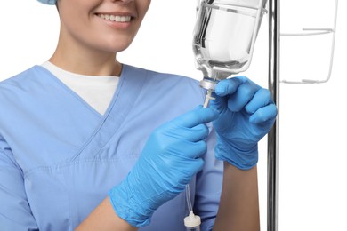 Photo of Nurse setting up IV drip on white background, closeup