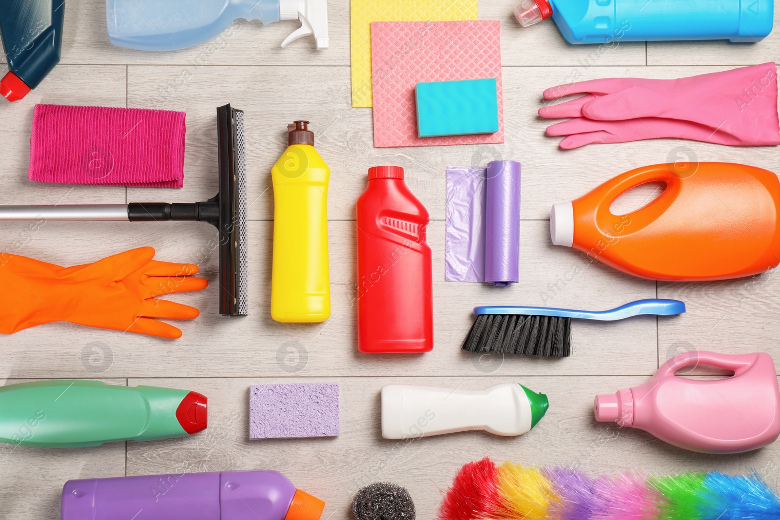 Photo of Flat lay composition with cleaning supplies on wooden background