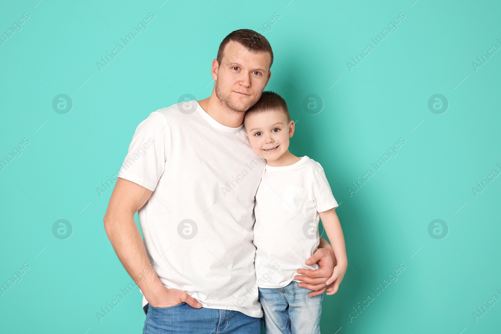 Photo of Dad and his son on color background. Father's day celebration