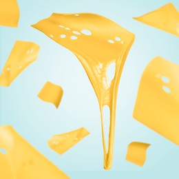 Image of Slices of cheese falling on light blue background