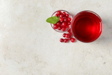Photo of Tasty refreshing cranberry juice, mint and fresh berries on light table, flat lay. Space for text