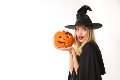 Photo of Beautiful woman in witch costume with jack o'lantern on white background, space for text. Halloween party