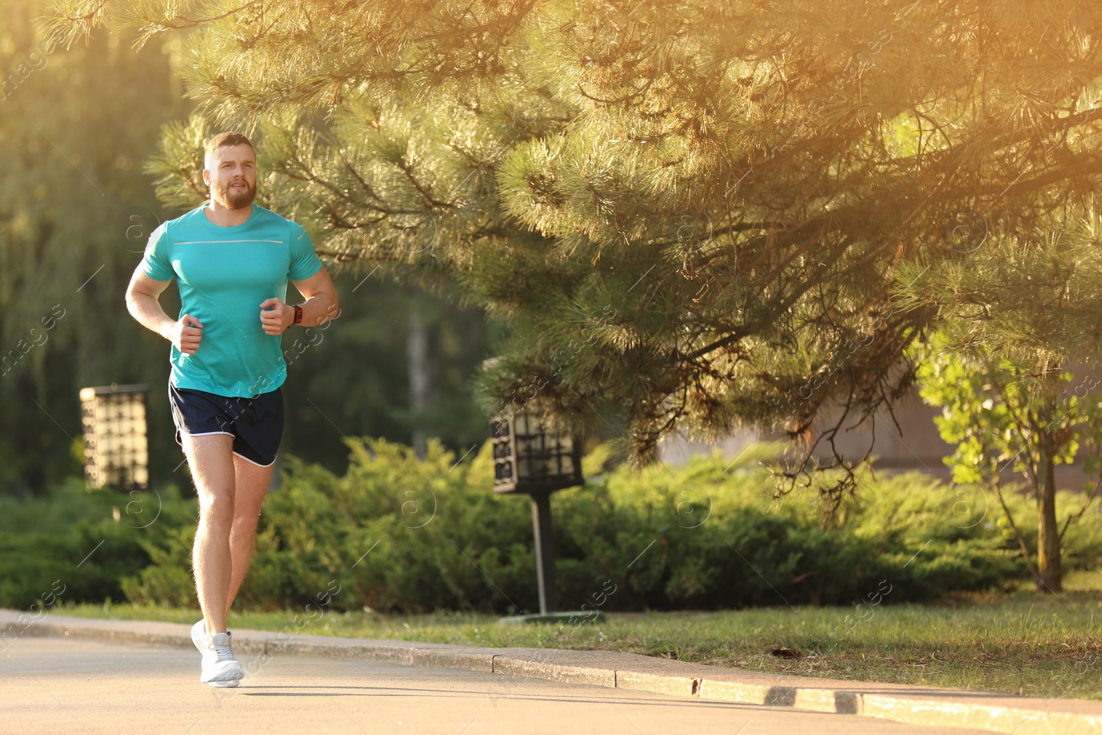 Photo of Young man running in park on sunny day