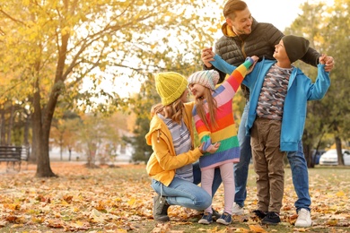 Photo of Happy family with children together in park. Autumn walk