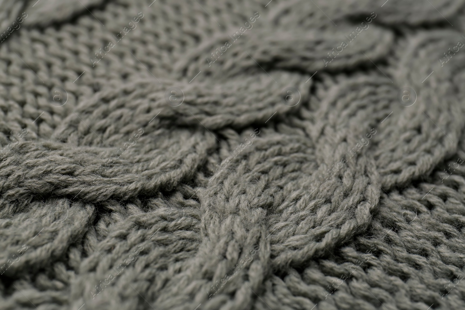 Photo of Knitted fabric with beautiful pattern as background, closeup