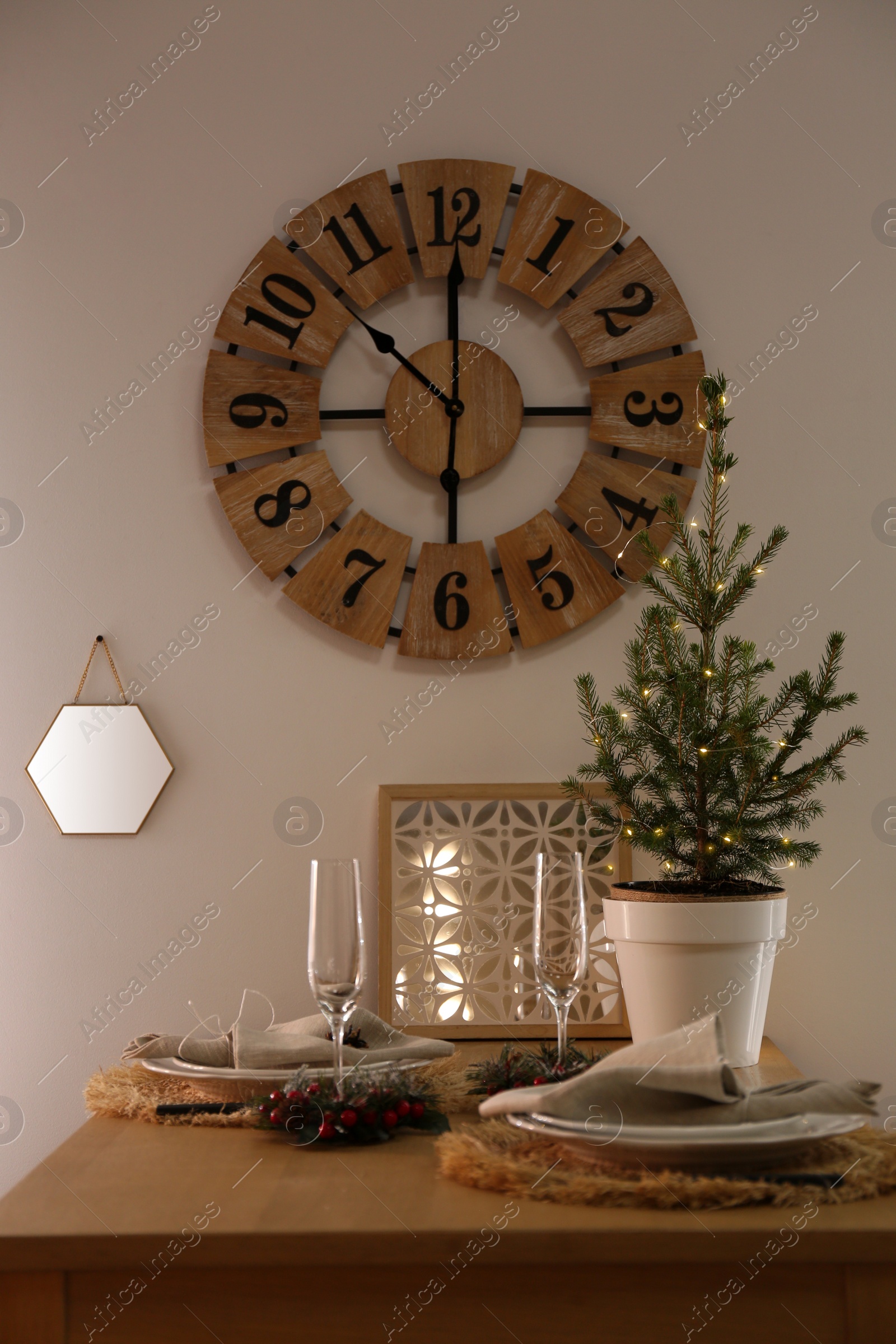 Photo of Small potted fir tree on dining table indoors. Interior design