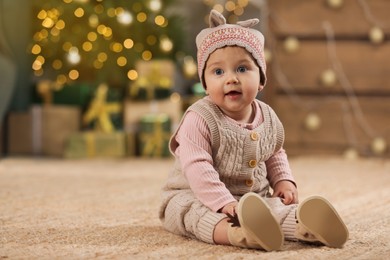 Photo of Cute little baby in room decorated for Christmas. Winter holiday