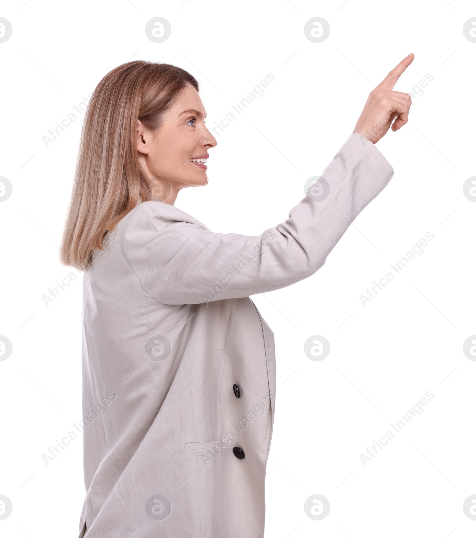 Photo of Beautiful happy businesswoman pointing at something on white background