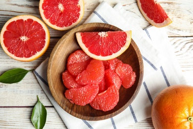 Photo of Flat lay composition with grapefruits on wooden background