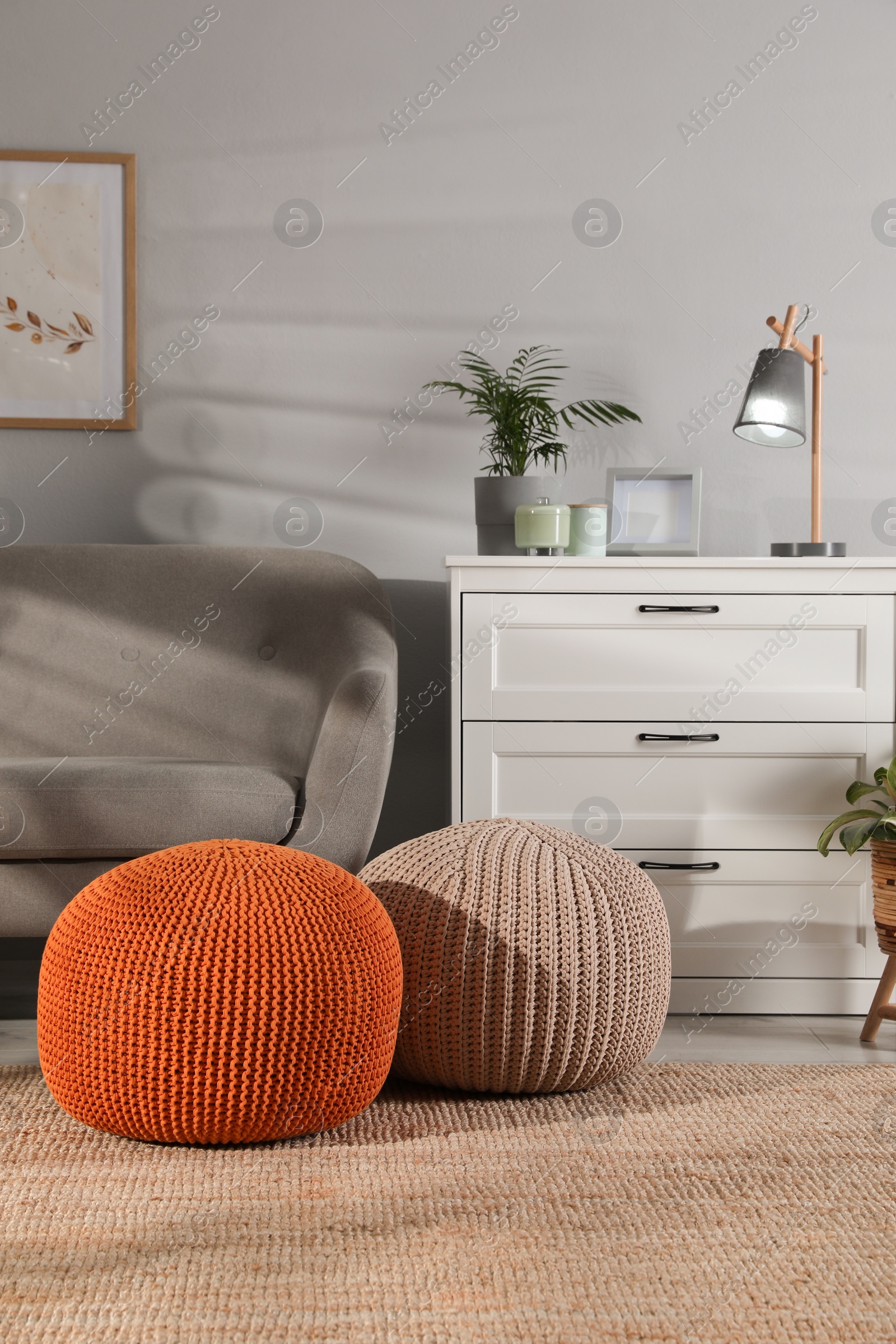 Photo of Stylish knitted poufs and sofa in living room. Home design