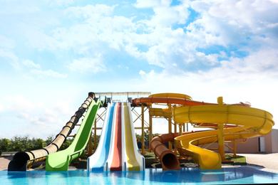 Different colorful slides in water park on sunny day