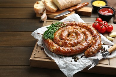 Photo of Delicious homemade sausage with spices served on wooden table