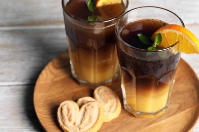 Photo of Tasty refreshing drink with coffee and orange juice on white wooden table