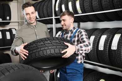 Photo of Service center consultant helping customer to choose tire in store