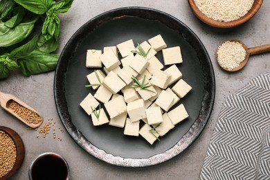 Photo of Delicious tofu with rosemary served on grey table, flat lay