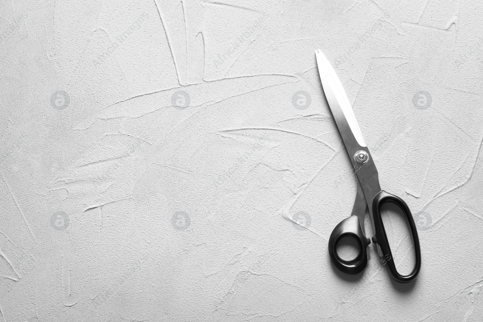 Photo of Scissors on light background, top view. Tailoring equipment