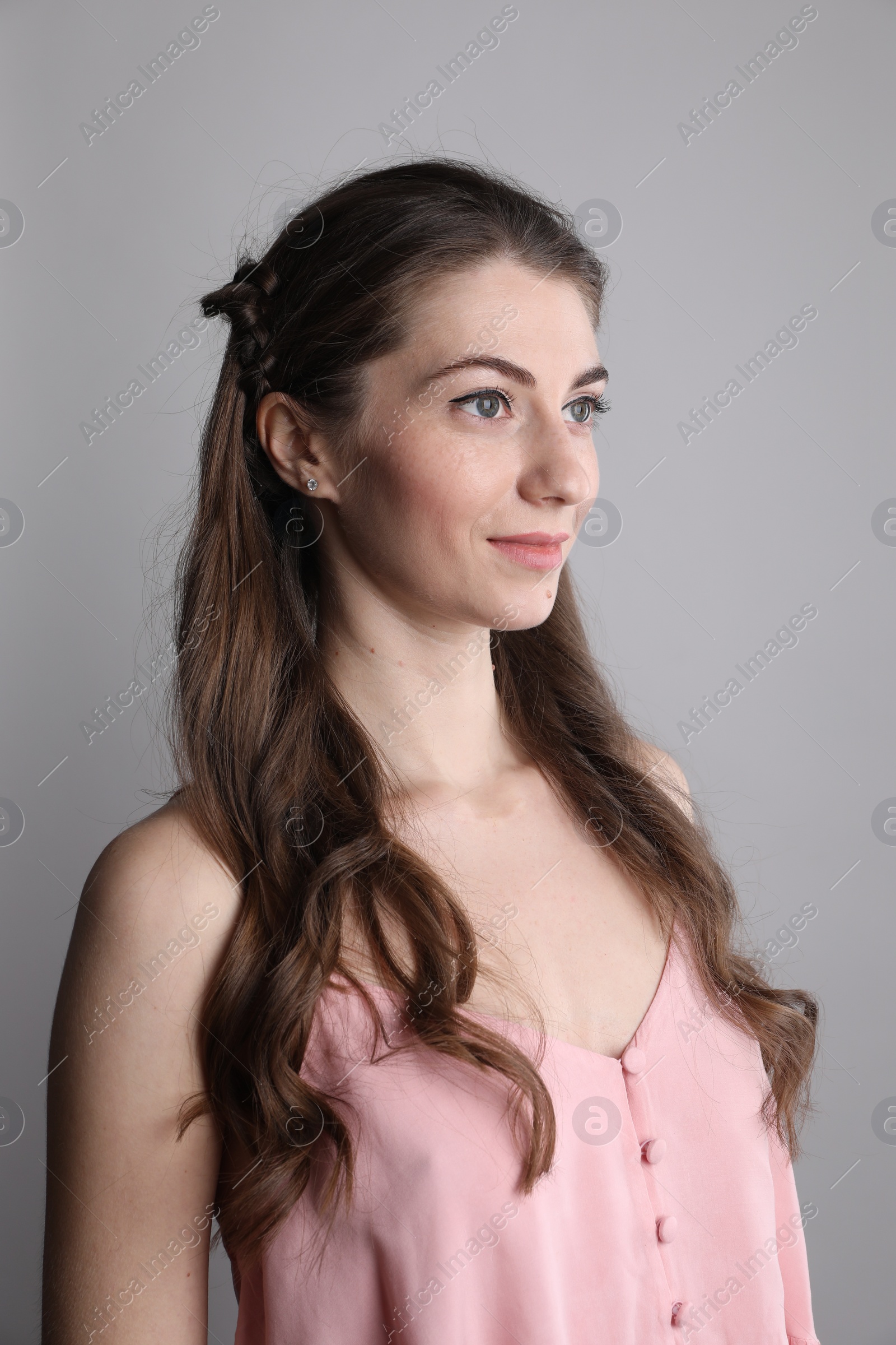 Photo of Woman with wavy hair on grey background