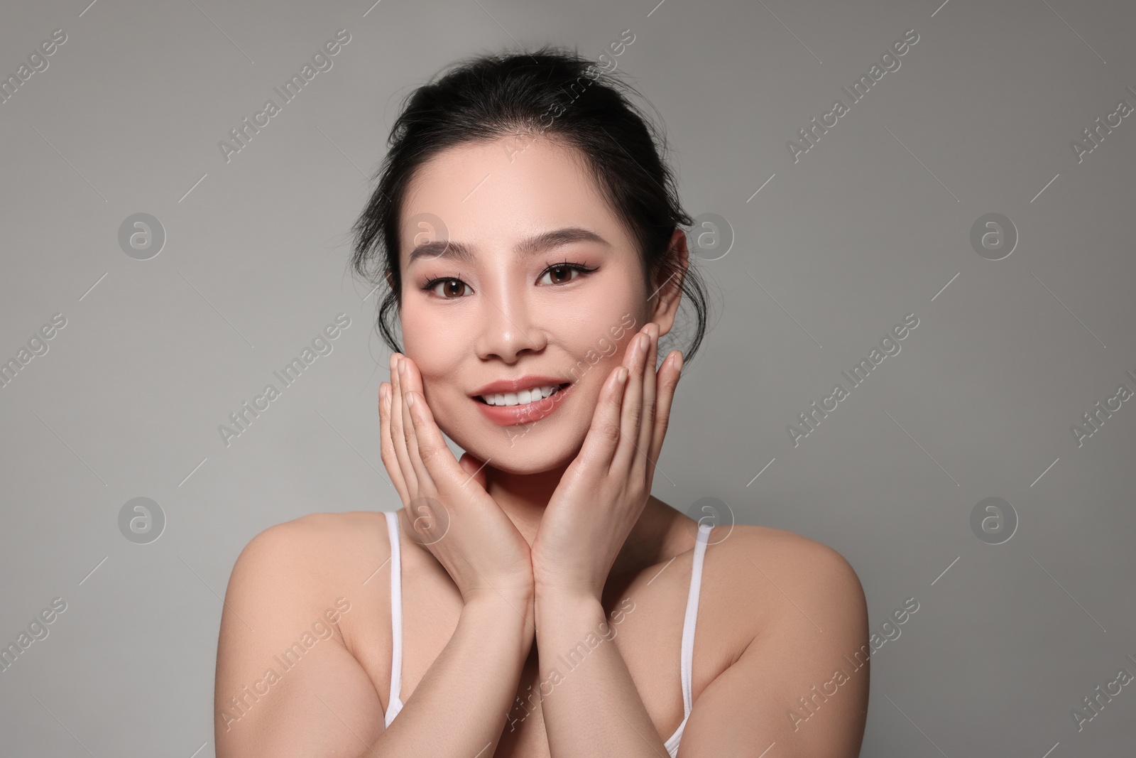 Photo of Portrait of beautiful woman on grey background