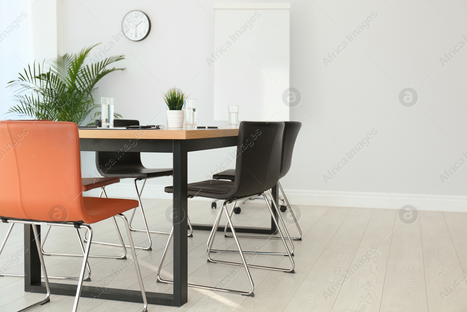 Photo of Simple office interior with large table and chairs