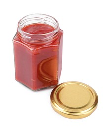 Organic ketchup in open jar isolated on white. Tomato sauce